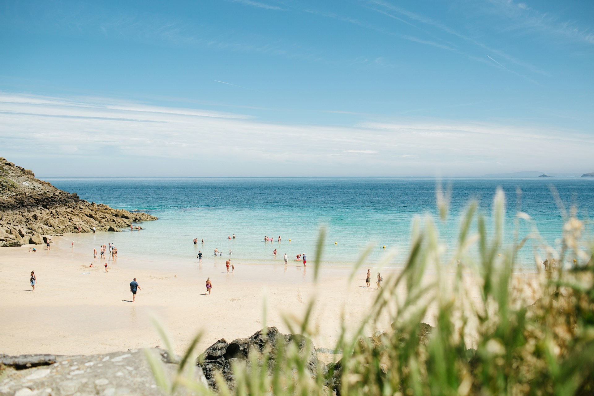moving to Cornwall. People on a Cornwall beach